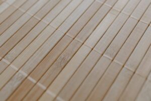 Detailed view of a bamboo mat showcasing its natural wood texture and minimalist design.