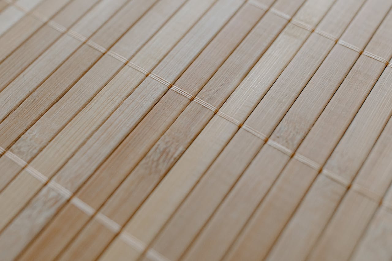 Detailed view of a bamboo mat showcasing its natural wood texture and minimalist design.