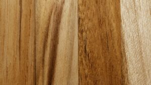 Close-up of a rich wooden surface showcasing a natural grain pattern and warm tones.