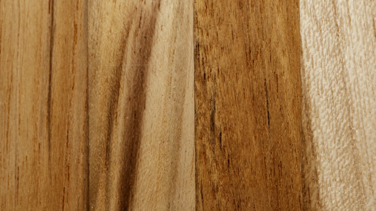 Close-up of a rich wooden surface showcasing a natural grain pattern and warm tones.